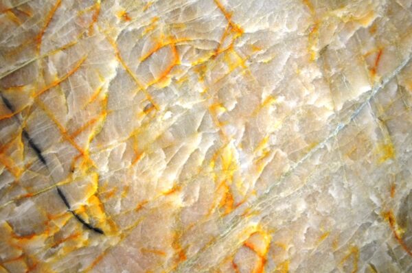 A true gem. Crystallo Gold features a crystalline structure with delicate golden veins. Its semi-translucent nature allows for backlighting, creating a glowing, golden masterpiece in your home.