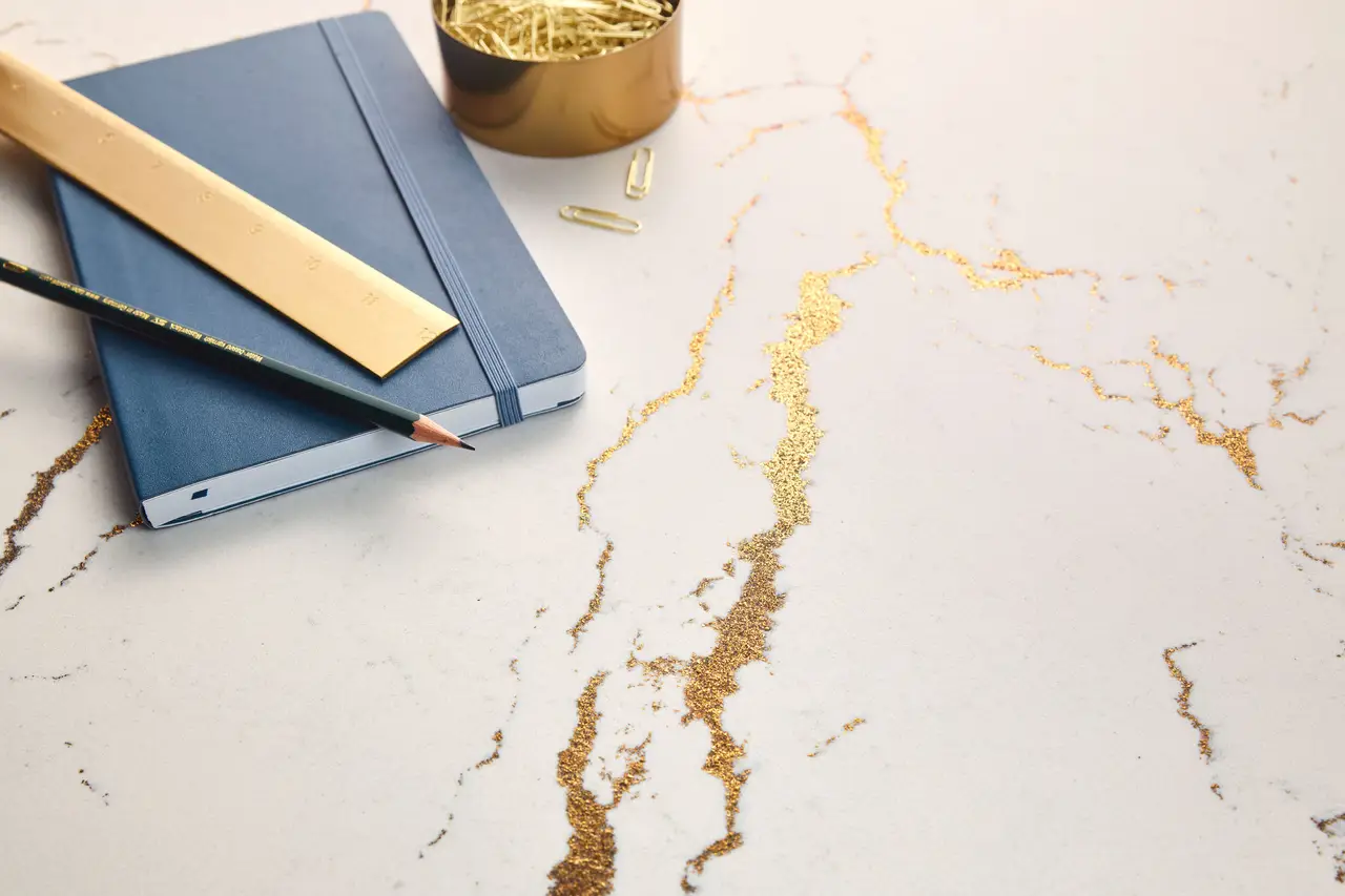 Premium quartz detail showing dramatic veining and warm brass accents