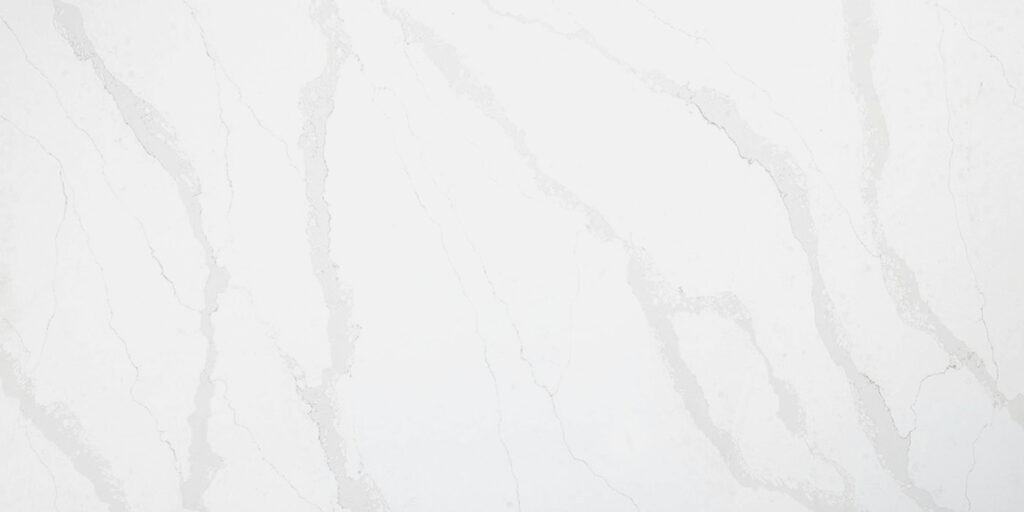 Calacatta Gold Jumbo Quartz by Venezia Surfaces with light gray quartz background and white gray movement