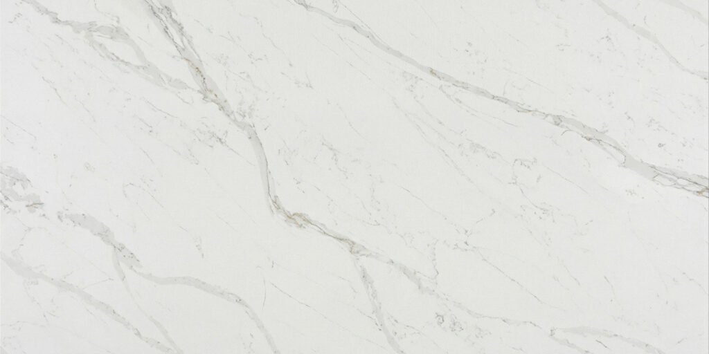 Calacatta Covelano Jumbo Quartz by Venezia Surfaces with white background and soft gray veining