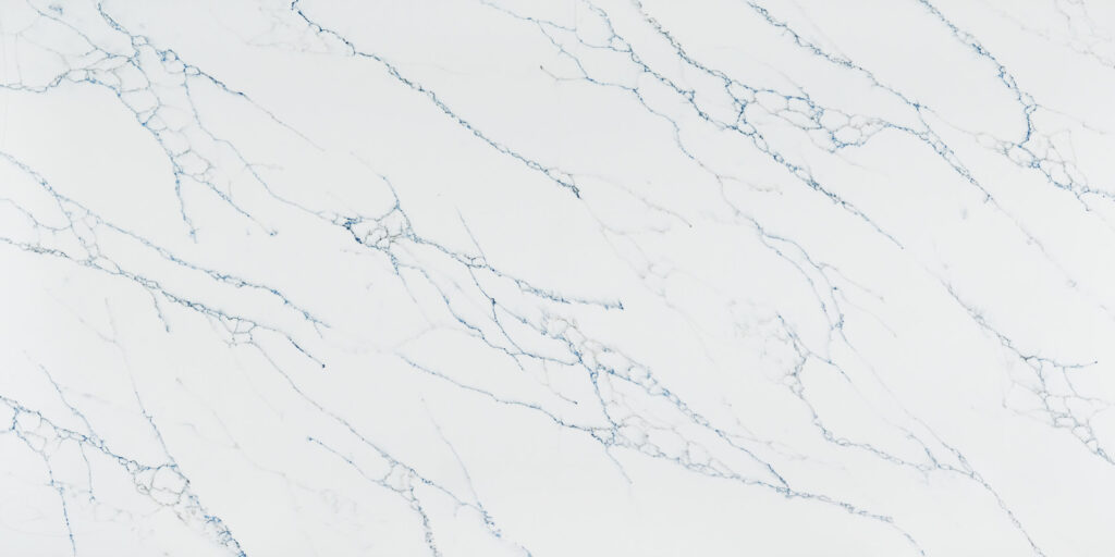 Calacatta Essence Jumbo Quartz by Venezia Surfaces with white background and thin gray-blue veins