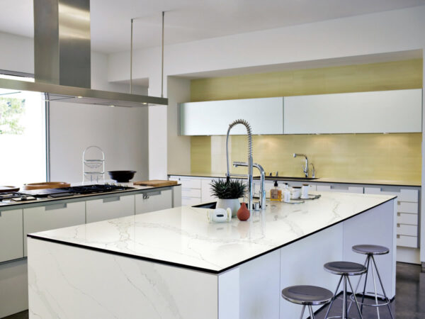Calacatta Gold Jumbo Quartz by Venezia Surfaces with light gray quartz background and white gray movement
