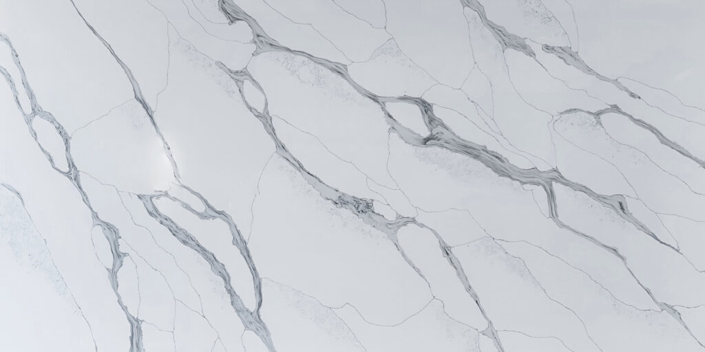 Calacatta Blue Jumbo Quartz by Venezia Surfaces with white background and blue gray veining