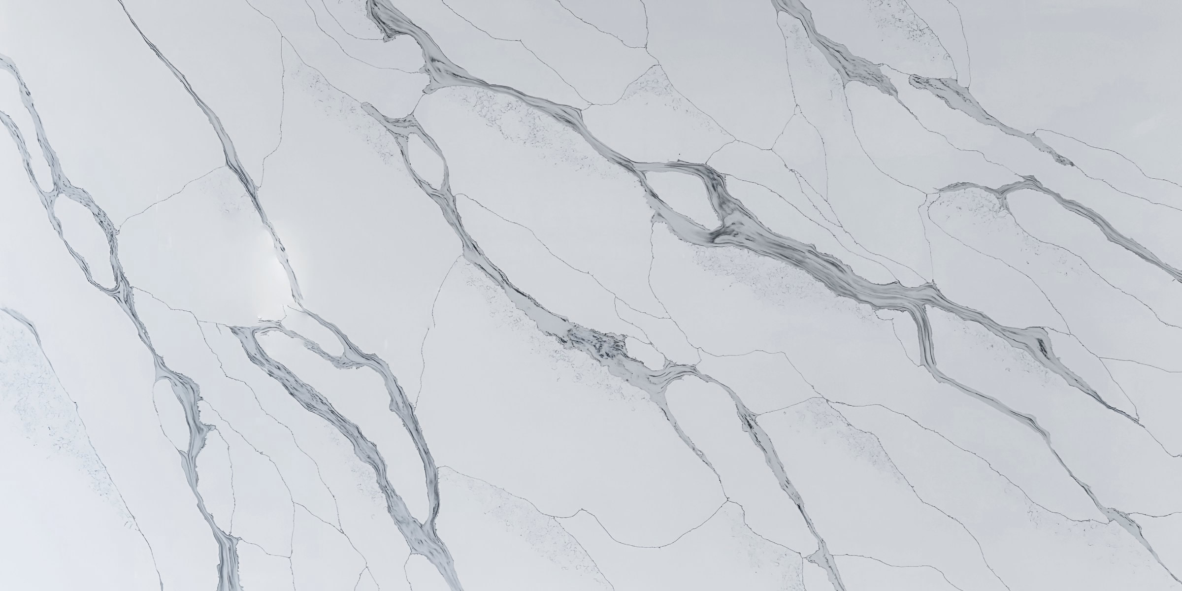 Calacatta Blue Jumbo Quartz by Venezia Surfaces with white background and blue gray veining