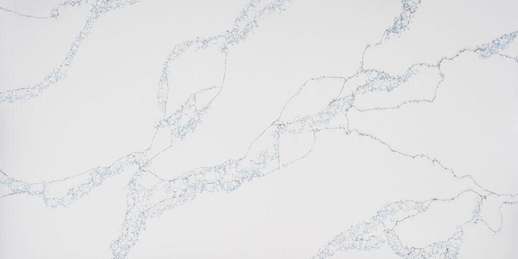 Calacatta Azure Black Fusion Jumbo Quartz by Venezia Surfaces with white background and blue gray veining