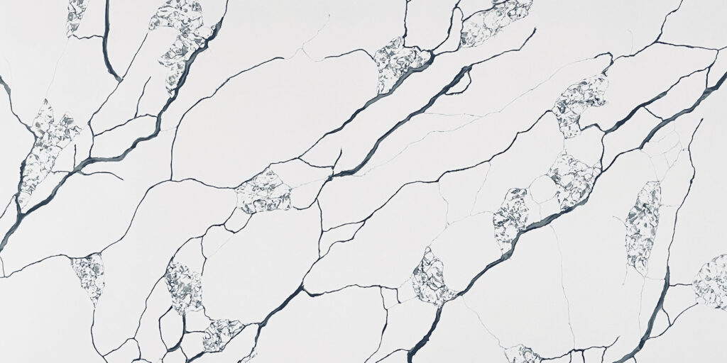 Calacatta Nest Jumbo Quartz by Venezia Surfaces with white background and bold black veining