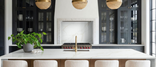 Modern kitchen featuring Calacatta Rivessa quartz countertops and large waterfall island.