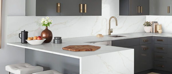 Modern kitchen featuring Calacatta Rivessa quartz countertops and large waterfall island.