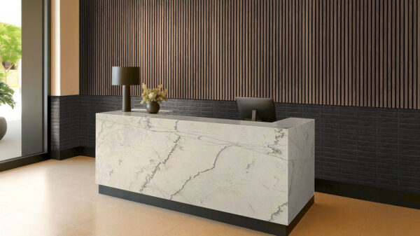 Calacatta Macaubas quartzite island beside dark wall panels