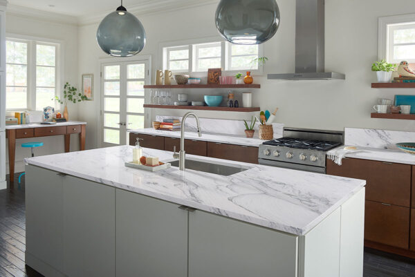 Florida Wave quartzite island and backsplash with gray cabinetry