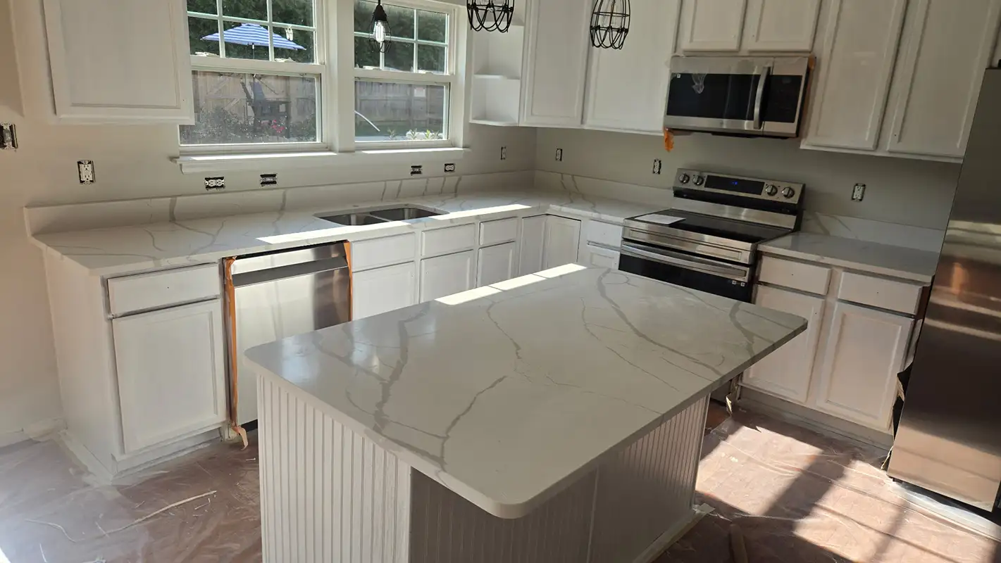 Calacatta Laza countertops and island installed in the kitchen; other renovation work is ongoing.
