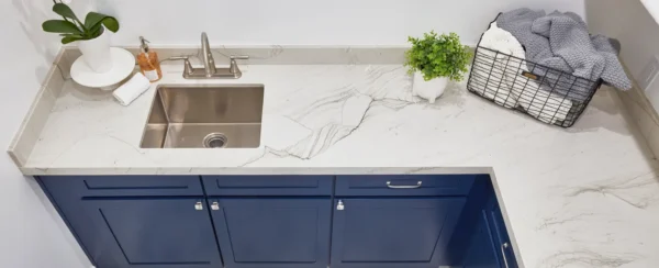 Mont Blanc quartzite countertop with a sink and blue cabinets