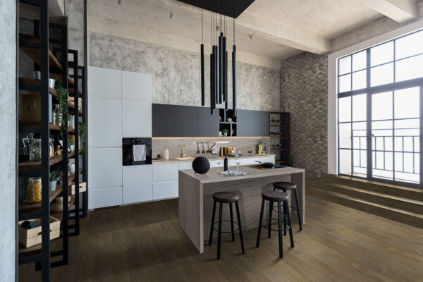 Sea Pearl quartzite island and wall backsplash with dark cabinets
