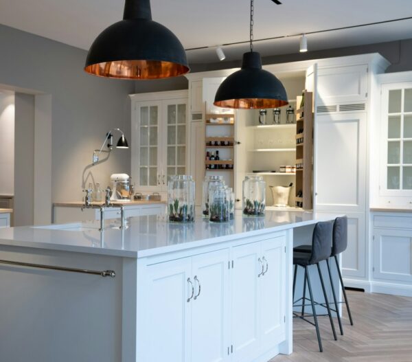Silestone Et Statuario pale veined island countertop under black and copper-toned pendant lights