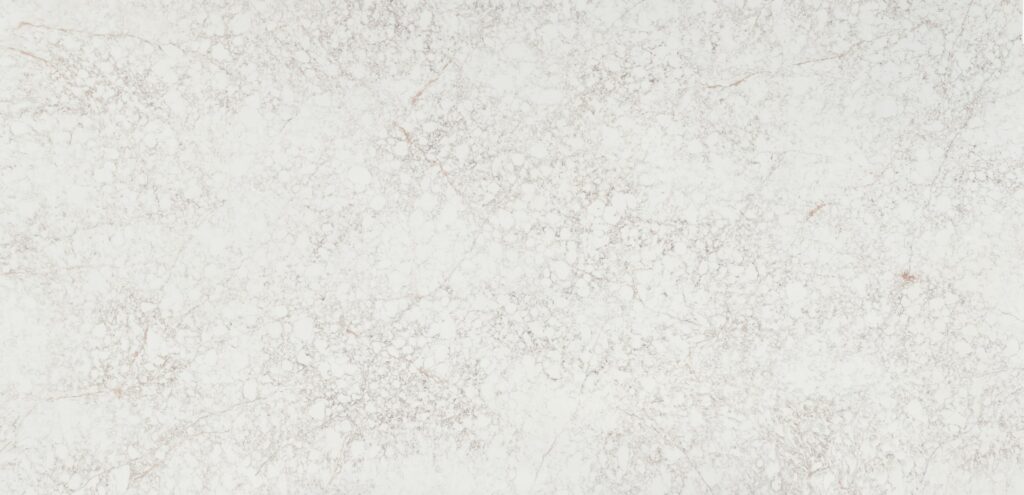 Silestone Riviére Rose full slab with a white background with a fine gray web pattern and pale rose-colored veins