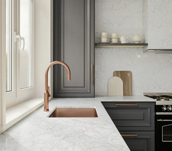 Riviére Rose Silestone countertop beside a copper-colored kitchen sink