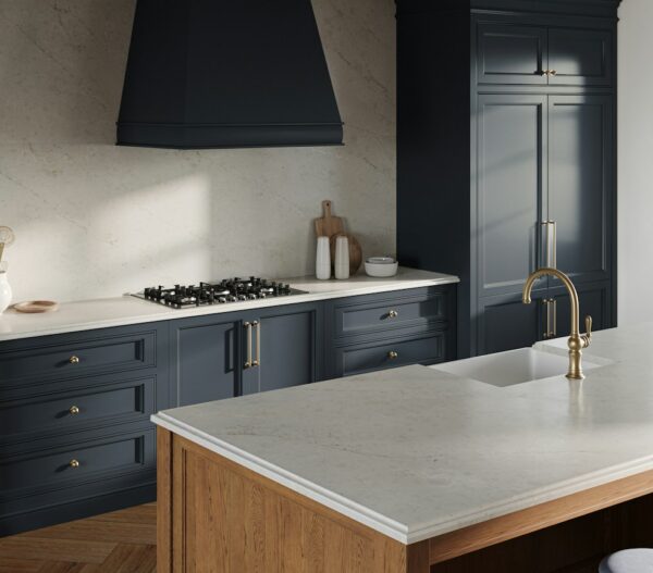 Soft Sand Silestone kitchen island and backsplash beside dark blue cabinets