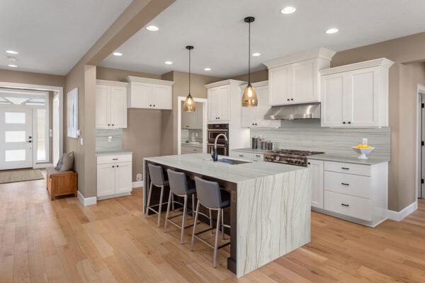 White Macaubas quartzite island and countertops with white cabinetry